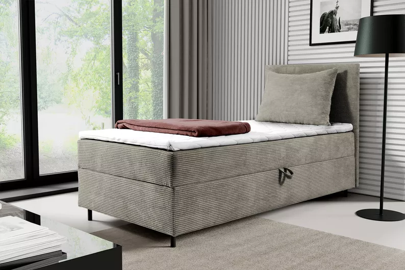 Łóżko kontynentalne jednosobowe Montigo Mini 70x200 cm z pojemnikiem, topperem i poduszką beżowe sztruks nogi czarne prawostronne
